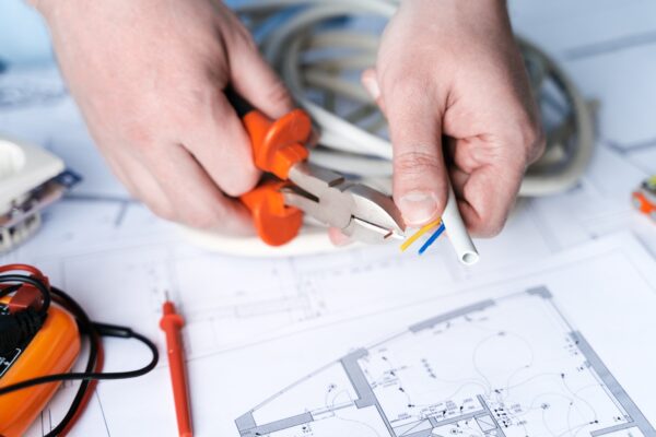 man-repairer-making-electricity-project-in-house-repairs-planning-drawing-diagrams-plan-of_t20_omyB4e